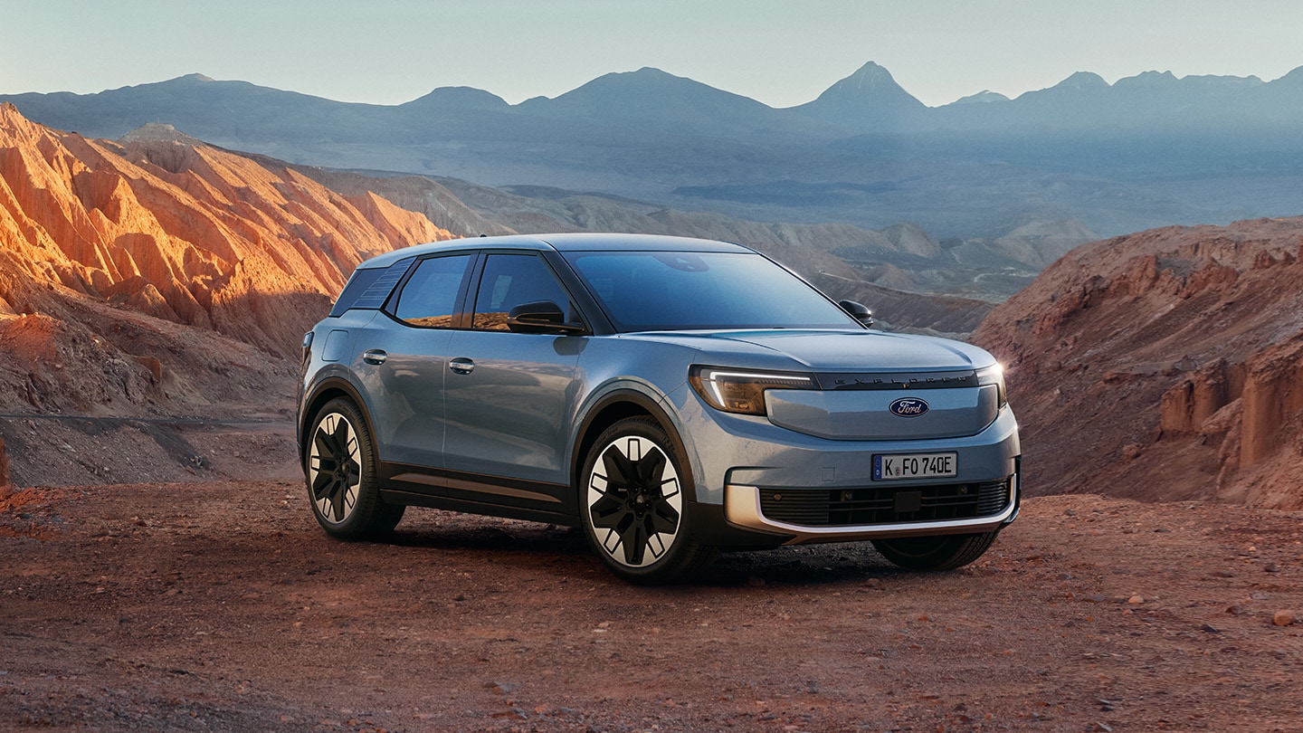 All-electric Ford Explorer on a sea road with the reddot winner 2024 badge